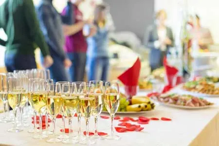Corporate event reception with a buffet and champagne glasses